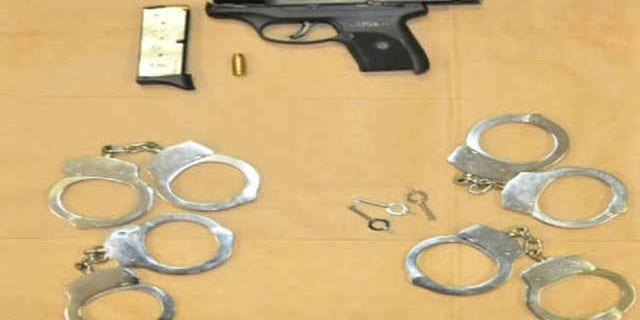 Cops say Neal Falls was carrying a pistol and handcuffs in his pocket.