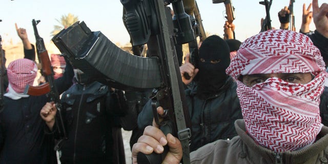 Jan. 7, 2014: Gunmen gather in a street as they chant slogans against Iraq's Shiite-led government and demanding that the Iraqi army not try to enter the city in Fallujah.