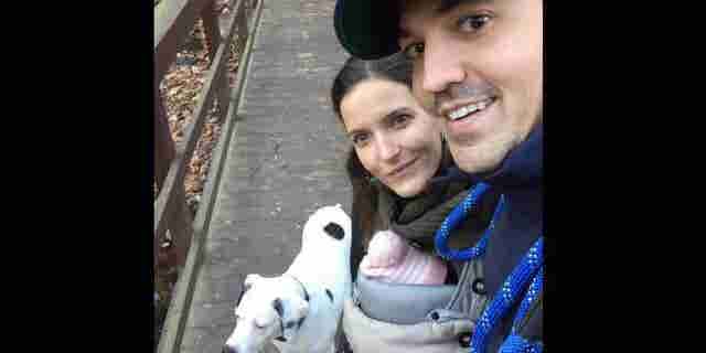 Christian Broder is seen with his wife, child and the family dog.