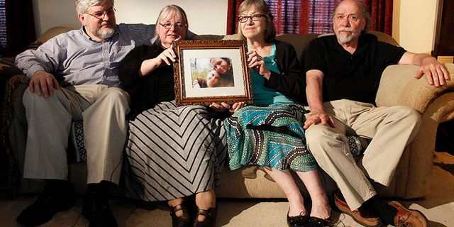 In this June 4, 2014, file photo, from left, Patrick Boyle, Linda Boyle, Lyn Coleman and Jim Coleman hold photo of their kidnapped children, Joshua Boyle and Caitlan Coleman, in Stewartstown, Pa.