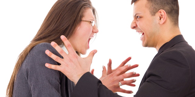 young angry couple fighting wanting to strange each other