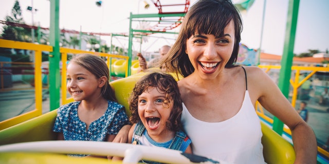 Meanwhile, 100 percent of kids in the middle seat of this photo would love to go to amusement parks on every single vacation.