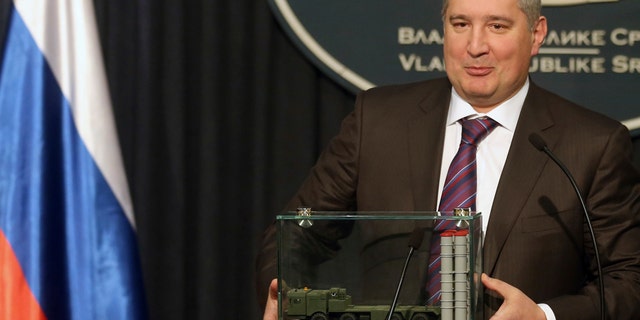 FILE - In this Monday, Jan. 11, 2016 file photo, Russian Deputy Prime Minister Dmitry Rogozin holds a model of an S-300 surface-to-air missile system at a news conference in Belgrade, Serbia. In May 2015, Rogozin invoked the X-37B unmanned space plane as evidence that his countryââ¬â¢s space program was faltering. ââ¬ÅThe United States is pushing ahead,ââ¬Â he warned Russian lawmakers. Less than two weeks later, the hacking group Fancy Bear tried to penetrate the Gmail account of a senior engineer on the X-37B project at Boeing. (Marina Lopicic/Kurir via AP)