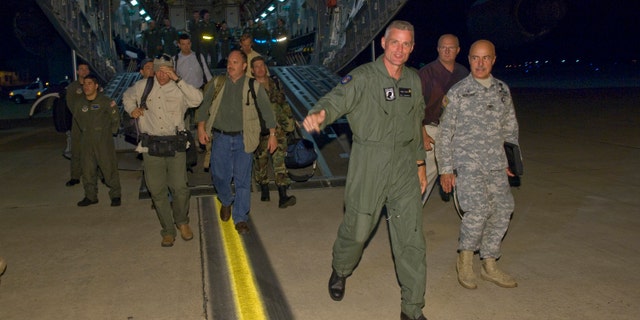 In a photo released by the the U.S. Air Force, Keith Stansell (3rd R) steps off the ramp of a C-17 Globemaster III July 2, 2008 at Lackland Air Force Base, Texas. Stansell, along with fellow military contractors Thomas Howes and Mark Gonsalves, was held captive for five years by the Revolutionary Armed Forces of Colombia (FARC).