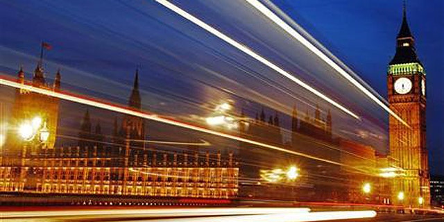 Light trails made by a passing bus illuminate the night sky in front of Britain's Houses of Parliament in London, February 4, 2010.