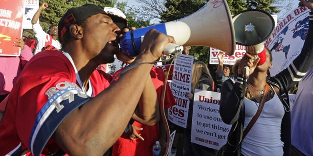 May 22, 2014: Protesters gather outside of the McDonald's Corporation headquarters in Oak Brook, Ill., the annual shareholders meeting demonstrating for higher wages and the right to unionize. (AP)