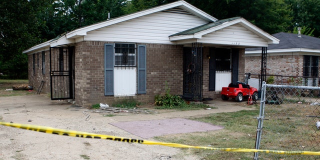 The outside of a Memphis home where a fire killed 11 people. Metal bars were placed over most windows of the house.