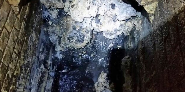In this undated handout photo issued by Thames Water on Tuesday, Sept. 12, 2017, a view of a fatberg inside a sewer in Whitechapel, London. British engineers say they have launched a sewer war against a giant fat blob clogging Londons sewers. Thames Water officials said Tuesday it is likely to take three weeks to dissolve the outsize fatberg. (Thames Water via AP)