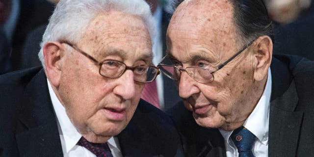 Henry Kissinger, left, talks to Hans-Dietrich Genscher, former foreign minister of West Germany prior to a memorial service in the St Nikolai Church marking the 25th anniversary of the peaceful German revolution in Leipzig, Germany in 2014.  (AP Photo/Jens Meyer, file)
