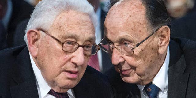 Henry Kissinger, left, talks to Hans-Dietrich Genscher, former foreign minister of West Germany prior to a memorial service in the St Nikolai Church marking the 25th anniversary of the peaceful German revolution in Leipzig, Germany in 2014.  (AP Photo/Jens Meyer, file)