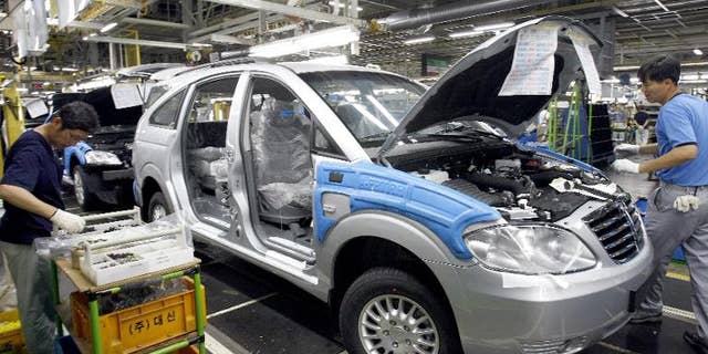 Illustration: Ssangyong Motor workers assemble cars on the production line in Pyeongtaek, South Korea