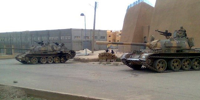 June 14: In this citizen journalism image made on a mobile phone and provided by Shaam News Network, a Syrian army tank is deployed in the Syrian eastern province of Deir el-Zour, Syria.