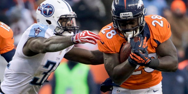 Tennessee Titans strong safety Bernard Pollard, left, tackles Denver Broncos running back Montee Ball during the second half of an NFL football game on Sunday, Dec. 8, 2013, in Denver. (AP Photo/Jack Dempsey)