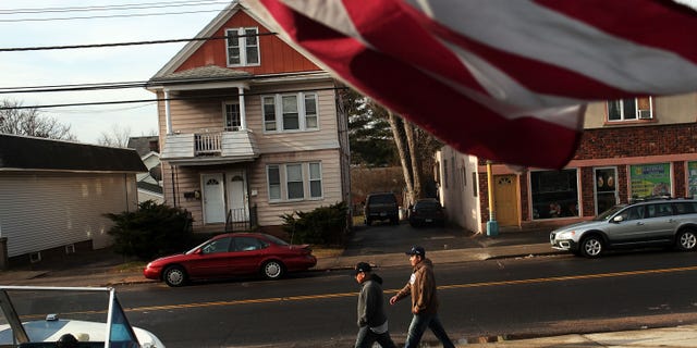 EAST HAVEN, CT - FEBRUARY 01: Two Latino residents walk down the street on February 1, 2012 in East Haven, Connecticut. Following an investigation by the FBI, four East Haven police officers were arrested last week and accused of abusing Latinos in the working class community of 28,000 people which was nearly predominately white a generation ago. A recent civil rights investigation which was released last month revealed a pattern of discriminatory policing in East Haven and the town has been warned by the U.S. Justice Department to make reforms. The arrested officers have been accused of subjecting Hispanics to beatings and false arrests among other things. Currently East Haven's Latino population is around 10 percent. (Photo by Spencer Platt/Getty Images)
