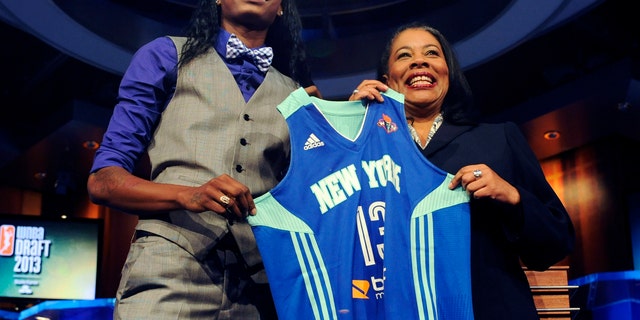 Oklahoma State's Toni Young holds up a New York Liberty jersey with WNBA president Laurel J. Richie after New York selected Young as the No. 7 pick in the WNBA basketball draft in Bristol, Conn., Monday, April 15, 2013. (AP Photo/Jessica Hill)