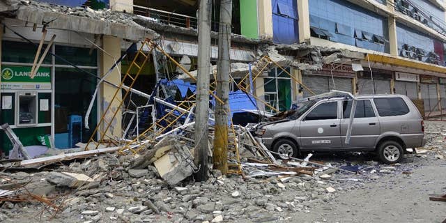 Fallen debris from a building are seen Saturday, Feb. 11, 2017 following a powerful nighttime earthquake that rocked Surigao city, Surigao del Norte province in southern Philippines. The late Friday quake roused residents from sleep in Surigao del Norte province, sending hundreds to flee their homes. (AP Photo)