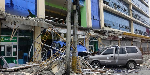 Fallen debris from a building are seen Saturday, Feb. 11, 2017 following a powerful nighttime earthquake that rocked Surigao city, Surigao del Norte province in southern Philippines. The late Friday quake roused residents from sleep in Surigao del Norte province, sending hundreds to flee their homes. (AP Photo)
