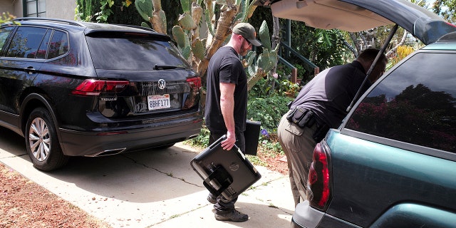 FBI agents remove evidence from the home of Robert Chain.