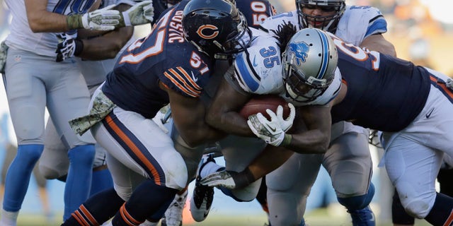 Detroit Lions running back Joique Bell (35) is tackled by Chicago Bears defenders during the second half of an NFL football game, Sunday, Nov. 10, 2013, in Chicago. The Lions won 21-19. (AP Photo/Nam Y. Huh)