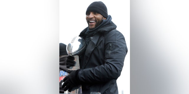 Baltimore Ravens linebacker Ray Lewis holds the Vince Lombardi trophy during a parade and celebration of the team's Super Bowl championship in Baltimore Tuesday, Feb. 5, 2013. The Ravens defeated the San Francisco 49ers 34-31 in Super Bowl XLVII on Sunday. (AP Photo/Steve Ruark)