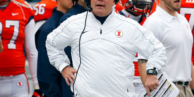 FILE - In this Nov. 16, 2013 file photo, Illinois head coach Tim Beckman watches a replay during the first half of an NCAA college football game against Ohio State in Champaign, Ill. Illinois confirmed Monday, Dec. 2, 2013 that Beckman will be back for a third season in 2014. Speculation about the second-year head coach's job security followed him through much of the 4-8 season that ended with the Saturday, Nov. 30 loss to Northwestern. (AP Photo/Jeff Haynes, File)