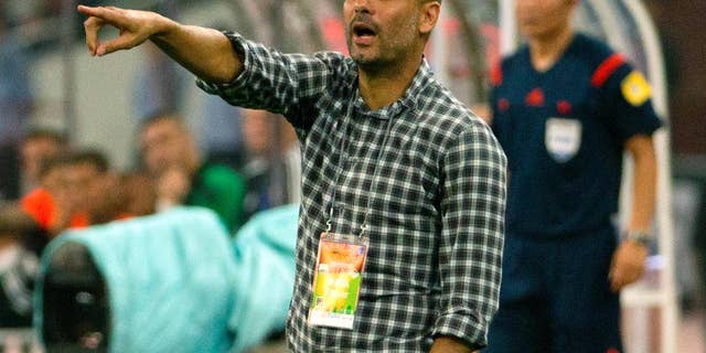 Bayern head coach Pep Guardiola gives instructions to his team during the second half of their friendly soccer match against Valencia in Beijing, Saturday, July 18, 2015. Bayern Munich beat Valencia, 4-1. (AP Photo/Mark Schiefelbein)