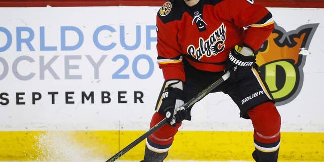 File-This March 11, 2016, file photo shows Calgary Flames' Dennis Wideman handling the puck during the first period of an NHL hockey game against the Arizona Coyotes,in Calgary, Alberta. The national Hockey League asked a Manhattan federal court judge Wednesday, June 8, 2016, to reject the reduction of Calgary Flames defenseman Dennis Wideman’s suspension for knocking down a linesman. An independent arbitrator reduced Wideman's suspension from 20 games to 10 after ruling that Wideman did not intend to injure linesman Don Henderson in Jan. 27 game against the Nashville Predators. The suspension has already been served. (Jeff McIntosh/The Canadian Press via AP) MANDATORY CREDIT