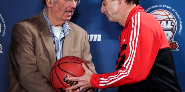 AP Basketball Writer Jim O'Connell, left, is honored by Louisville coach Rick Pitino after a news conference for the NCAA Final Four tournament, Sunday, April 7, 2013, in Atlanta. Louisville plays Michigan in the basketball championship game on Monday. Covering his 35th Final Four, AP Basketball Writer Jim O'Connell was honored by the NCAA and the Final Four coaches today. (AP Photo/Chris O'Meara)