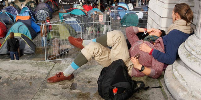 Oct. 27, 2011: People lie on the steps outside St Paul's Cathedral in London.