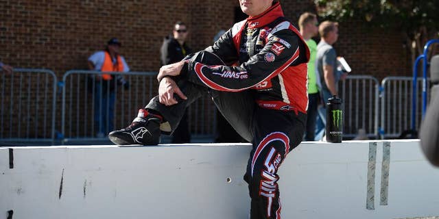 Kurt Busch looks on before qualifying for a NASCAR Sprint Cup series auto race, Friday, Sept. 26, 2014, at Dover International Speedway in Dover, Del. (AP Photo/Nick Wass)