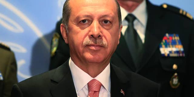 Turkey's President Recep Tayyip Erdogan, poses for photographs with military chiefs of Balkan nations following his speech at their conference, in Istanbul Wednesday, May 11, 2016. Erdogan said Turkish forces have killed some 3,000 Islamic State militants in Syria and Iraq, insisting that no other country has matched Turkey's efforts against the extremist group. At the same meeting earlier however, the Turkish military chief, put the number of IS militants killed Syria and Iraq at 1,300. (AP Photo/Lefteris Pitarakis)
