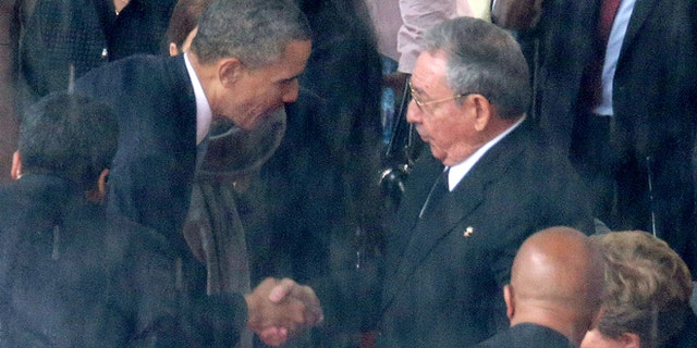 Obama and Castro during the official memorial service for former South African President Nelson Mandela December 10, 2013.