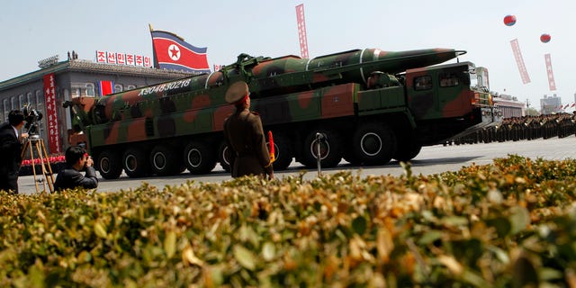 A North Korean vehicle purported to be carrying a new missile passes through a Pyongyang military parade.