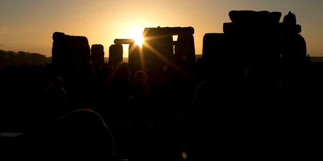 File photo - Dec. 21, 2012: The sun passes through the stones after rising at the ancient stone circle of Stonehenge, in southern England, as access to the site is given to druids, New Age followers and members of the public on the annual Winter Solstice.