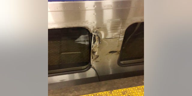 In this image provided by Jordan Geary shows the side of a New Jersey Transit train that is damaged, Friday, March 24, 2017 in New York's Penn Station. The train clipped an Amtrak Acela Express during the morning rush at Penn Station, jolting commuters and creating major travel disruptions but causing no serious injuries. (Jordan Geary via AP)