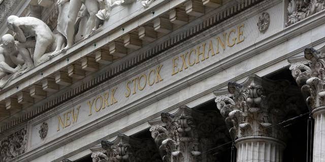 FILE - This Oct. 2, 2014 file photo shows the facade of the New York Stock Exchange, in New York. U.S. stocks opened higher Wednesday, April 8, 2015, as investors waited for the release of minutes from the Federal Reserve's latest meeting. Investors were also waiting for companies to start reporting their first-quarter earnings. Alcoa, a metals company, will be one of the first major companies to report earnings after the close of the market. (AP Photo/Richard Drew, File)