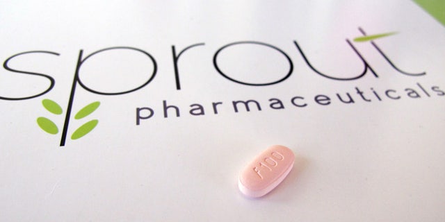 In this June 22, 2015, photo, a tablet of flibanserin sits on a brochure for Sprout Pharmaceuticals in the company's Raleigh, N.C., headquarters. Sprout soon may succeed where many of the world's largest pharmaceutical companies have failed: in winning Food and Drug Administration (FDA) approval for flibanserin, dubbed Addyi, the first drug to boost women's sexual desire.