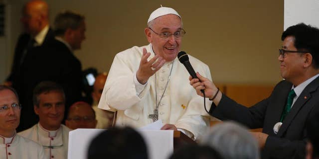 Pope Francis addresses South Korean Catholics during a meeting at the Spirituality Center in Kkottongnae in Eumseong, South Korea, Saturday, Aug. 16, 2014. (AP Photo/Kim Hong-Ji, Pool)