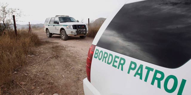 FILE - In this Thursday, Dec. 16, 2010 file photo, U.S. Border Patrol vehicles come and go from a checkpoint, as teams of border officers comb through the Arizona desert about 10 miles north of Mexico in search of the lone outstanding suspect in the fatal shooting of Border Patrol agent Brian Terry in the rugged terrain in Rio Rico, Ariz. The shooting Tuesday night came after agents spotted suspected bandits known for targeting illegal immigrants along a violent smuggling corridor. State Sen. Steve Smith, R-Maricopa, was the sponsor of a bill that was signed into law recently that will use donated money and inmate labor to build a "secure fence" along the U.S.-Mexico border. (AP Photo/Ross D. Franklin, file)