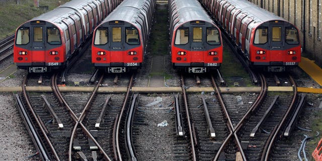 FILE - In this Monday, Dec. 26, 2011 file photo, Underground trains are parked during a 24-hour strike by train drivers over public holiday pay, at Mordern depot, south London. Millions of commuters face travel woes as workers at London’s underground transport network, the Tube, prepare to go on strike. A walkout is scheduled to start later Tuesday, Feb. 4, 2104, through to Thursday, and a second one is due Feb 11-13. (AP Photo/Sang Tan, File)