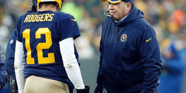 Green Bay Packers head coach Mike McCarthy talks to Aaron Rodgers during the first half of an NFL football game against the Philadelphia Eagles Sunday, Nov. 16, 2014, in Green Bay, Wis. (AP Photo/Mike Roemer)