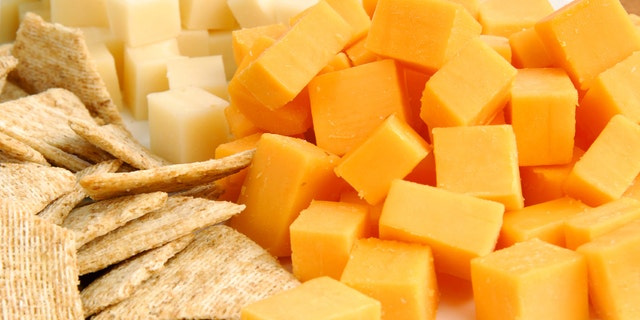 A party tray with swiss and cheddar cheese and crackers