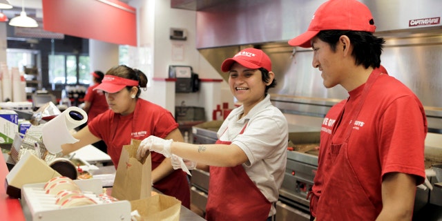 Manager Kely Guardado (C) prepares hamburgers at a Five Guys restaurant in Washington, May 26, 2010. The weak U.S. economy is no match for fast-growing Five Guys Burgers and Fries, where the standard hamburger has two patties and french fries are served in a cup with an extra scoop on the side for good measure. Picture taken May 26, 2010. To match Analysis RESTAURANTS/ REUTERS/Yuri Gripas (UNITED STATES - Tags: FOOD BUSINESS) - RTR2EFDK