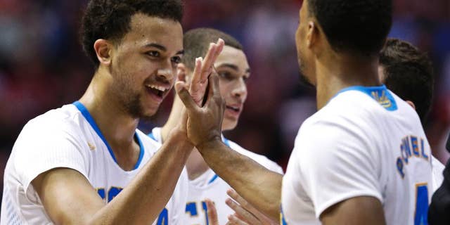 UCLA 's Kyle Anderson and Norman Powell, right, celebrate during the second half of a third-round victory over Stephen F. Austin in the NCAA college basketball tournament, Sunday, March 23, 2014, in San Diego. (AP Photo/Gregory Bull)