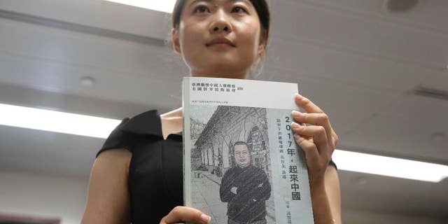 Grace Geng, the daughter of one of China's most prominent human rights lawyers, Gao Zhisheng, attends at the Hong Kong launch of a book, titled “Stand Up China 2017 - China's Hope: What I Learned During Five Years as a Political Prisoner”, written by her father, at a news conference in Hong Kong, Tuesday, June 14, 2016. The book is a memoir by Gao in which he details the torture he says he endured while detained and jailed as well as three years of being held in solitary confinement. (AP Photo/Kin Cheung)