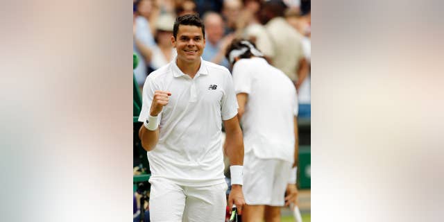 Milos Raonic of Canada celebrates after beating Roger Federer of Switzerland in their men's semifinal singles match on day twelve of the Wimbledon Tennis Championships in London, Friday, July 8, 2016. (AP Photo/Alastair Grant)