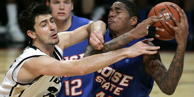Idaho's Kyle Barone, left, and Boise State's Kenny Buckner (42) go after a loose ball during the first half of an NCAA college basketball game on Thursday, Dec. 20, 2012, in Boise, Idaho. (AP Photo/Matt Cilley)