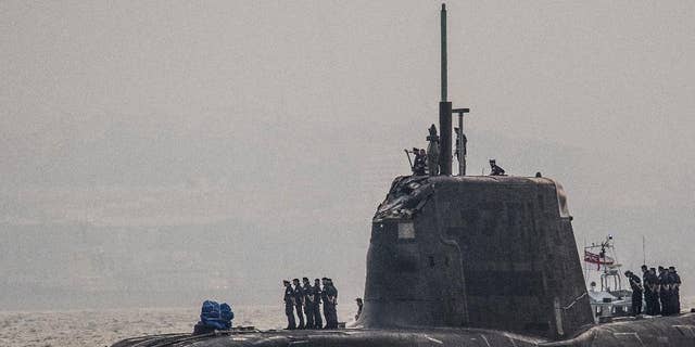 In this Wednesday July 20, 2016, British Royal Navy submarine HMS Ambush's  arrives into the Naval Base at Gibraltar. A British Royal Navy submarine has been forced into port after colliding with a merchant vessel off the coast of Gibraltar. The navy said Wednesday that HMS Ambush's nuclear reactor was not damaged in the incident when the Astute-class submarine became "involved in a glancing collision with a merchant vessel" while submerged and conducting a training exercise. (AP Photo/David Parody)