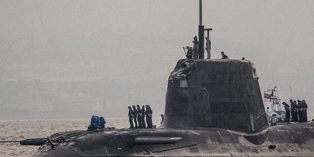 In this Wednesday July 20, 2016, British Royal Navy submarine HMS Ambush's arrives into the Naval Base at Gibraltar. A British Royal Navy submarine has been forced into port after colliding with a merchant vessel off the coast of Gibraltar. The navy said Wednesday that HMS Ambush's nuclear reactor was not damaged in the incident when the Astute-class submarine became "involved in a glancing collision with a merchant vessel" while submerged and conducting a training exercise. (AP Photo/David Parody)