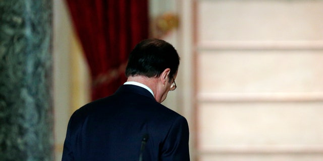 French President Francois Hollande leaves after his annual news conference, Tuesday, Jan.14, 2014 at the Elysee Palace in Paris. Hollande is promising to cut 50 billion euros in public spending over 2015-2017 to try to improve the indebted economy. Hollande, a Socialist, came to office in 2012 on pledges to avoid the painful austerity measures carried out by neighboring Spain and Italy. But France’s economy has suffered two recessions in recent years and growth is forecast at an anemic 0.2 percent in 2013. (AP Photo/Christophe Ena)